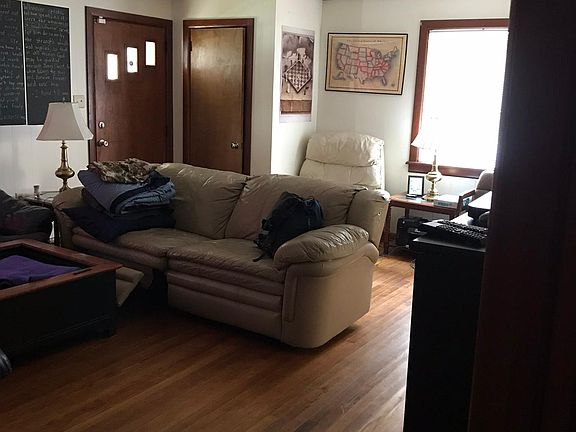 Brick fireplace with wood insert on opposite wall