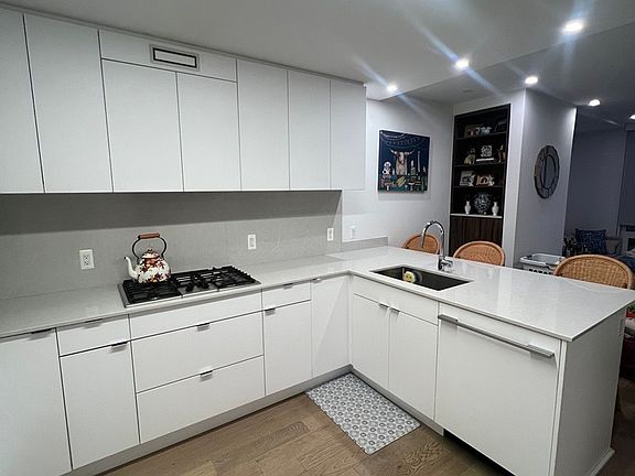 Kitchen with bar overlooks into the living room.