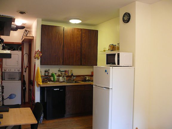 Kitchen space has ample storage and includes a microwave-convection oven behind the refrigerator/freezer