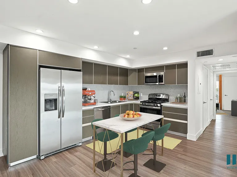 Open-Concept Kitchen with Staineless-Steel Refrigerator, Stove, Microwave Oven, and Dishwasher