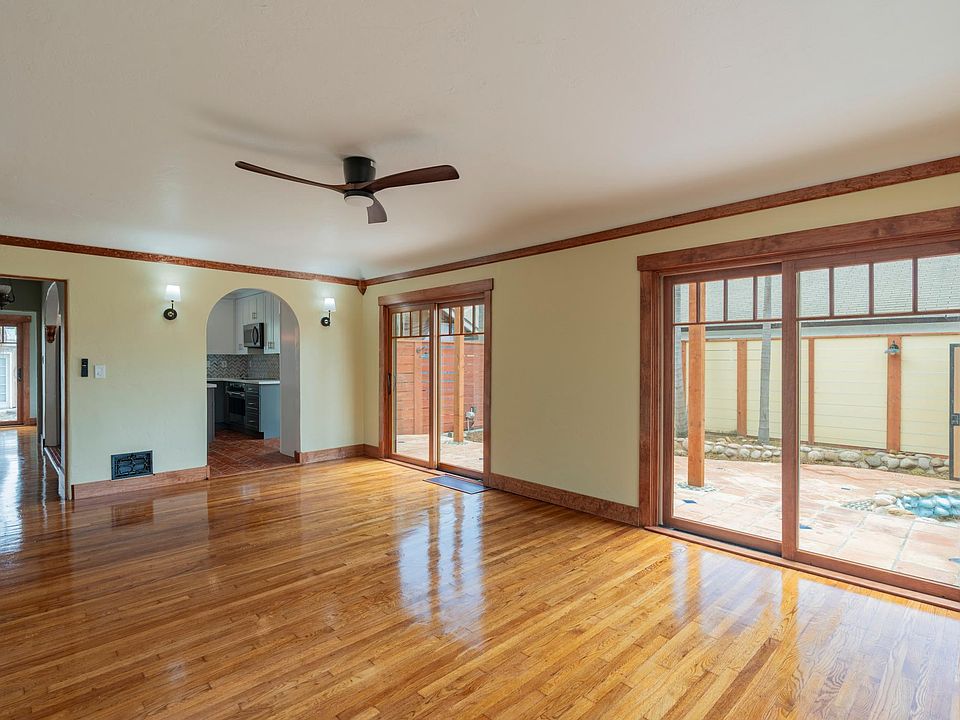 Living room, refinished hardwood floors, and French doors to courtyard