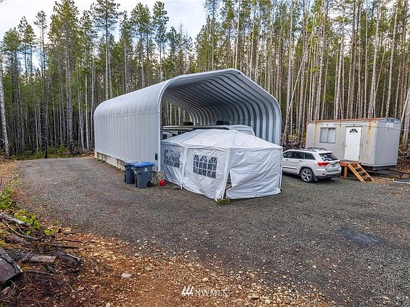 Large 30 X 40 Quonset Building currently used to house the two RVS. The car canopy and the two metal storage buildings do not convey. 