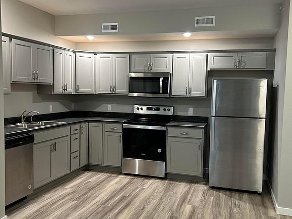 Stainless steal appliances, electric stove, lazy Susan corner cabinet.