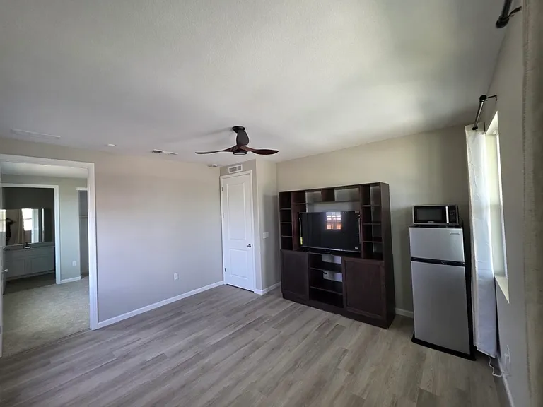 Private living room - brand new 50" smart tv provided, tv console, small fridge/freezer and microwave provided.