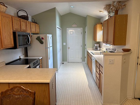 Kitchen. To the right is the entry doorway. Far door leads to garage.