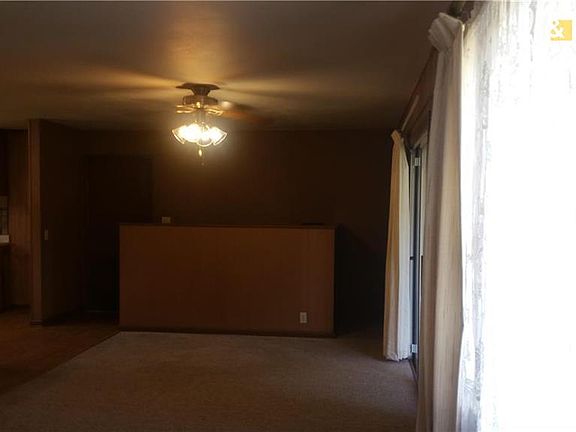 Dining area with half wall, stairs to the basement behind the half wall.