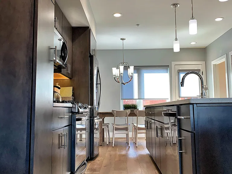 Plenty of cabinet-space and brand new, high-end appliances fill the kitchen