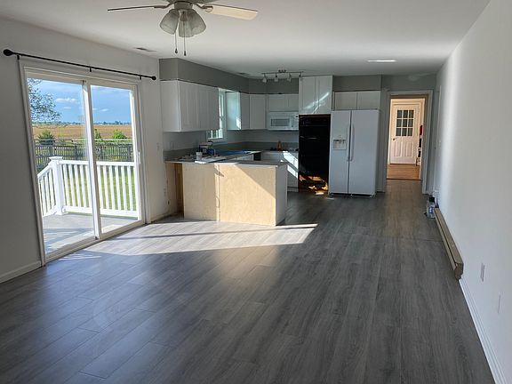 View off slider to back yard. Extra room off kitchen in back ground to garage.