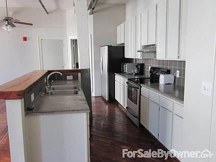 Grourmet Kitchen
						:
						Poured concrete counters and stainless steel appliances.