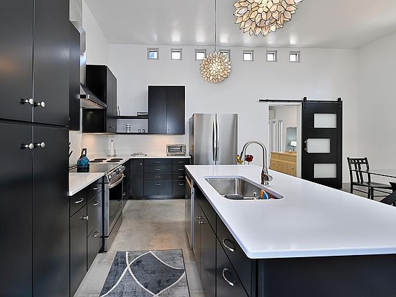 Kitchen view. Notice the beautiful, modern, barn door separating living space from bedroom space.