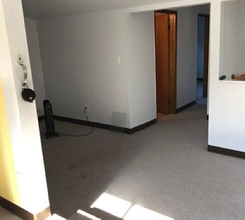 Living room with hallway to bathroom and bedrooms