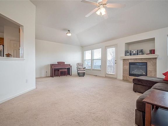 Spacious Living Room with Gas Fireplace and Ceiling Fan.
