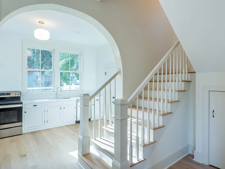View from the entryway into the kitchen. There is a sizeable closet under the stairs, great for storing beach chairs, coolers, etc!