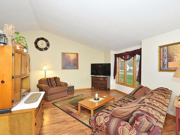 Vaulted ceilings create a wonderful open layout on the main level! Notice large front window for natural light!