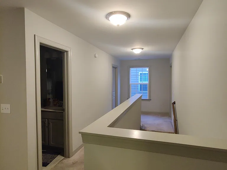 Upstairs hall, bathroom door look from game room.