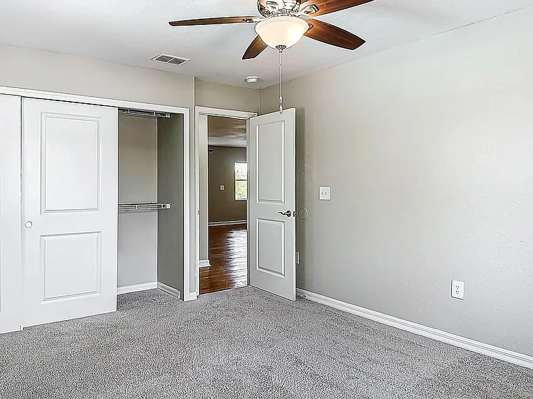 Bedrooms feature spacious closets with built-in organizers providing ample storage.