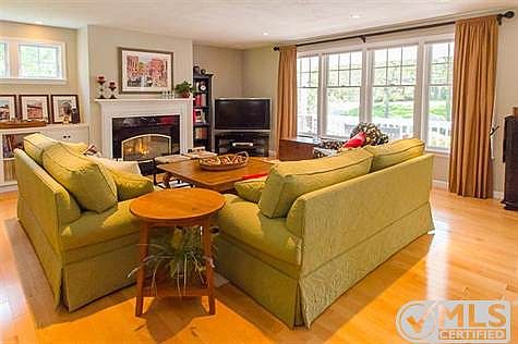 Gracious Living Room with gas fireplace and oversized windows