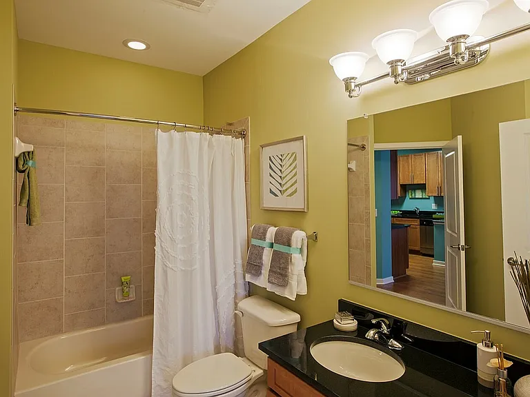 Large Bathroom With Tiled Shower, Granite Vanity Counter, Ample Storage Space & Modern Lighting