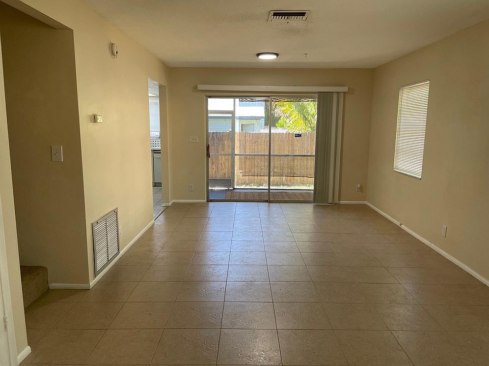 Living room with tile flooring & multiple windows