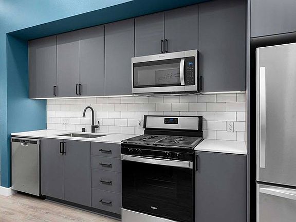 Building B Urban Design kitchen with quartz countertops, backsplash and stainless steel appliances