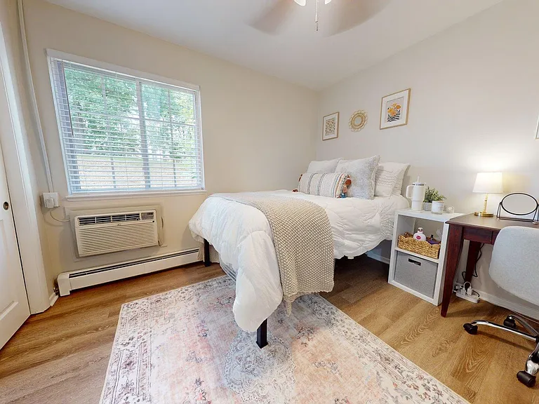 Inviting bedroom with cozy bed, elegant desk, and bright window lighting the space, perfect for relaxation and productivity. Inviting bedroom with cozy bed, elegant desk, and bright window lighting the space, perfect for relaxation and productivity.