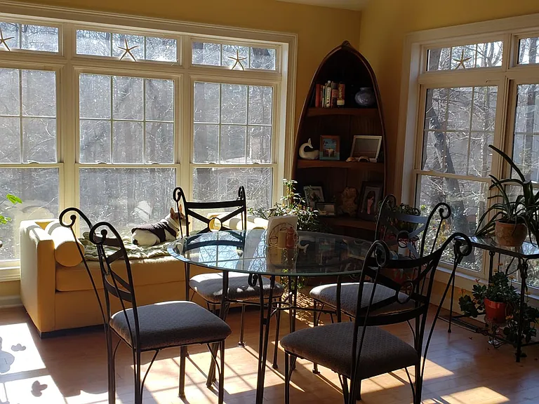 Dining area with beautiful views of water and woods. Watch the deer as you eat your breakfast!