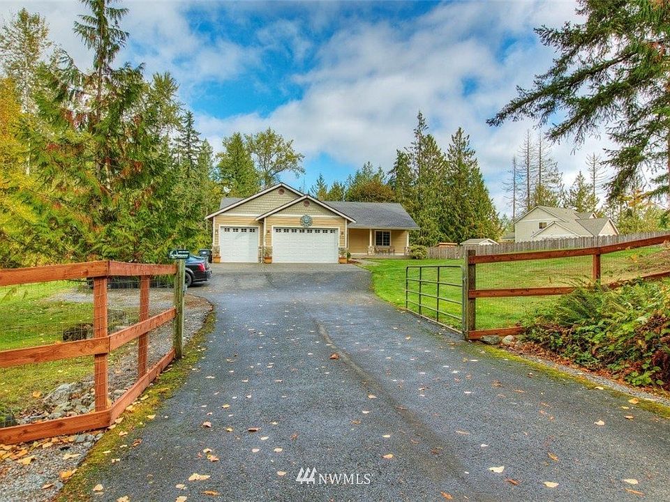 Impressive custom-built rambler on shy 5 acres, mature trees afford privacy.  Long paved driveway with gated entry...abundant parking! 