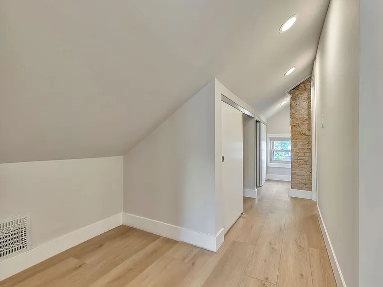There are two large closets in this space and exposed brick to the bath entrance.