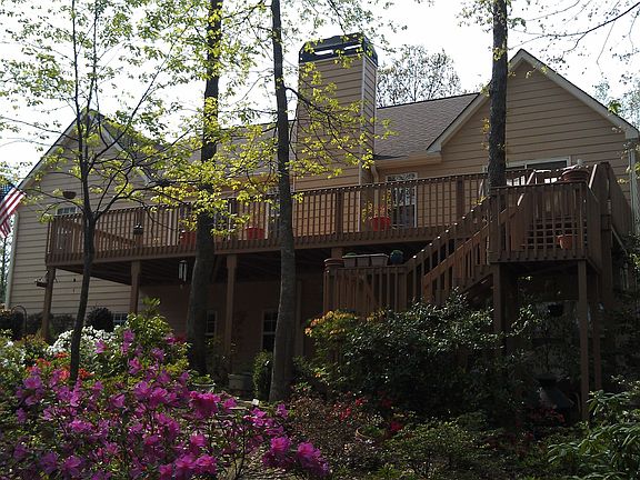 back of house, also under deck full concrete patio