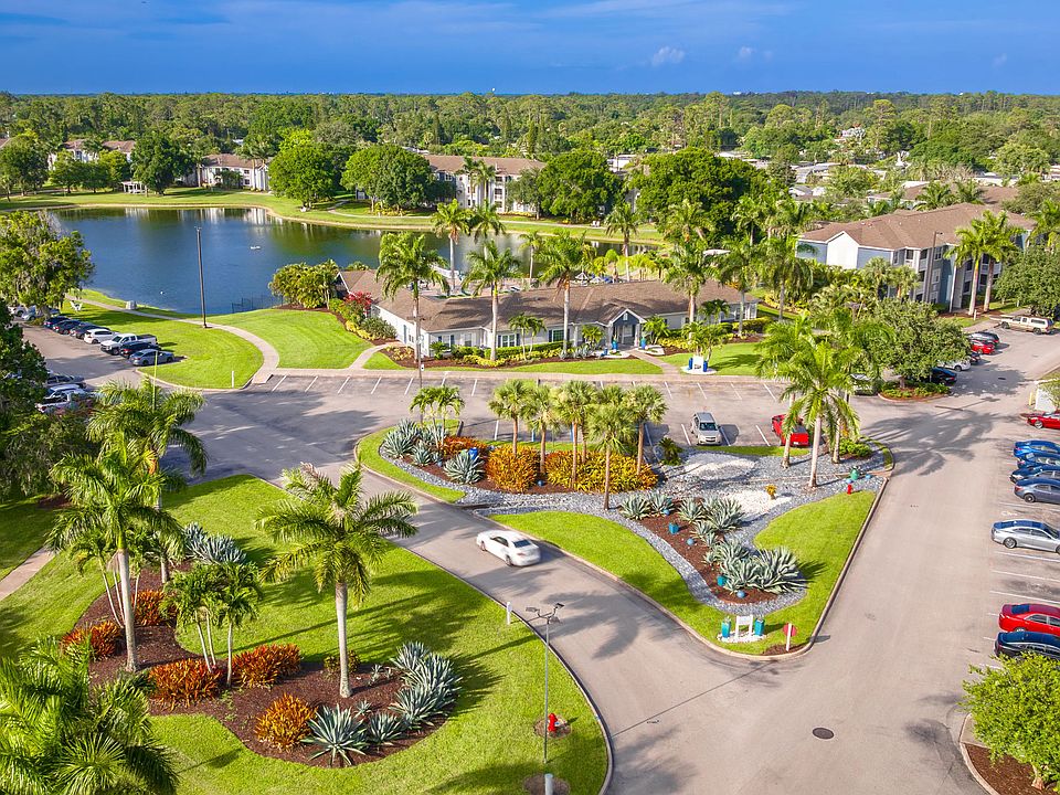 From the moment you enter, enjoy vibrant landscaping, tropical greenery, and a peaceful lakeside backdrop.