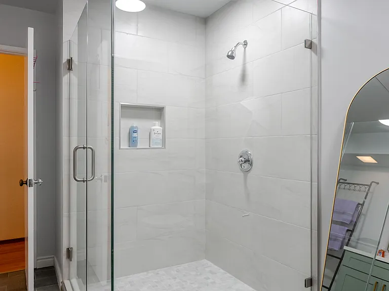 Step into comfort with a spacious walk-in shower for a refreshing experience.