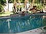 pool/manicured yard with hot tub