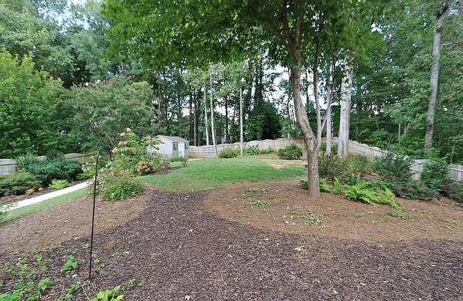 THIS PROPERTY HAS THE LARGEST BACK YARD IN THE SUBDIVISION!. Relaxing back yard features winding pathway leading to large back shed ideal for yoga practice or office. Yes there is power.