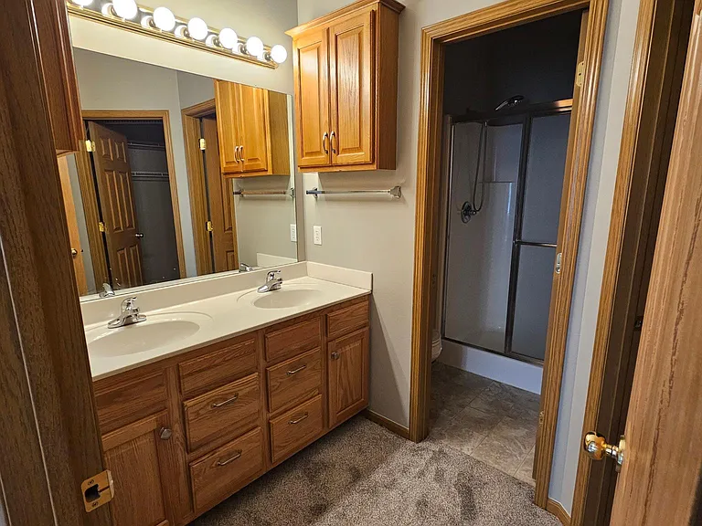 Master bathroom with dual sinks, toilet room and shower.