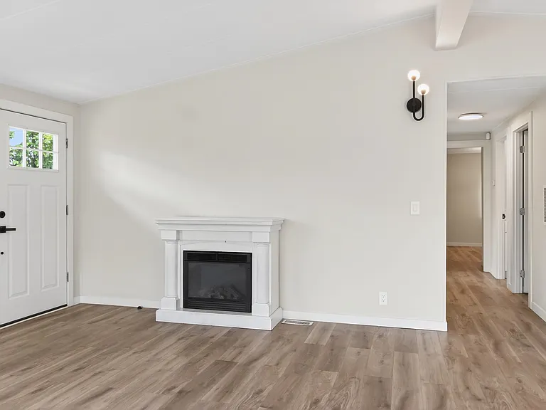 Living Room with Electric Fireplace and Front Entry