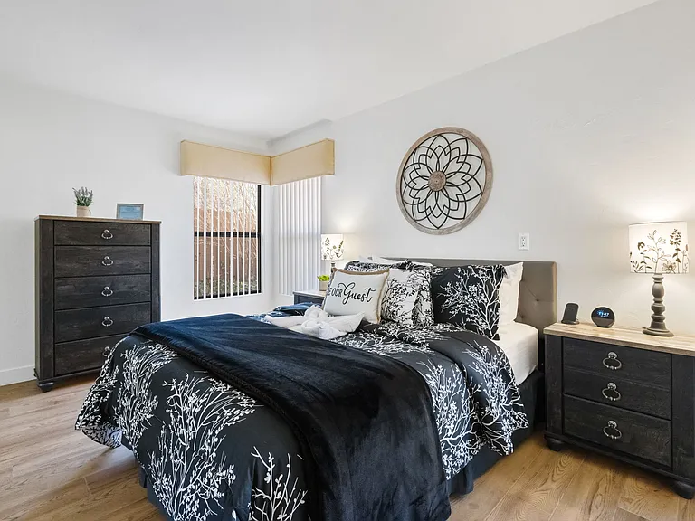 Bedroom 2 features a queen bed and l back Patio access.