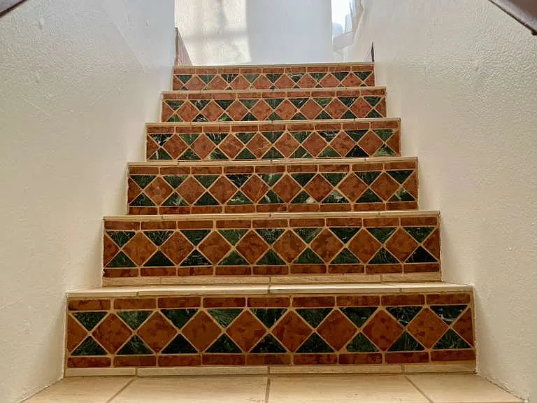 Stairwell to second floor, porcelain tiles, ceramic risers, cathedral rise ceiling