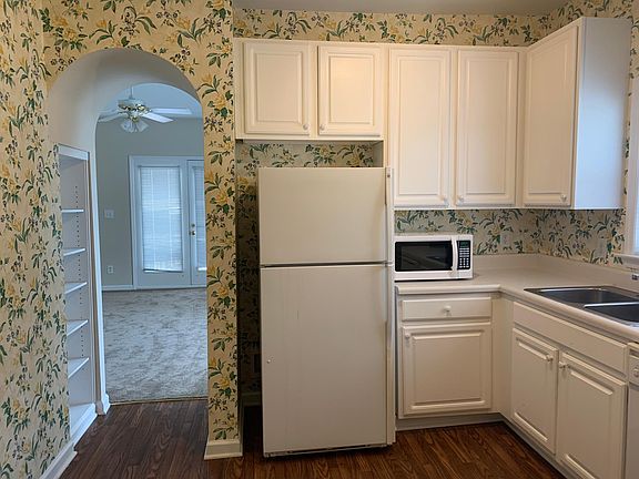Walkway to living room has built in bookcase