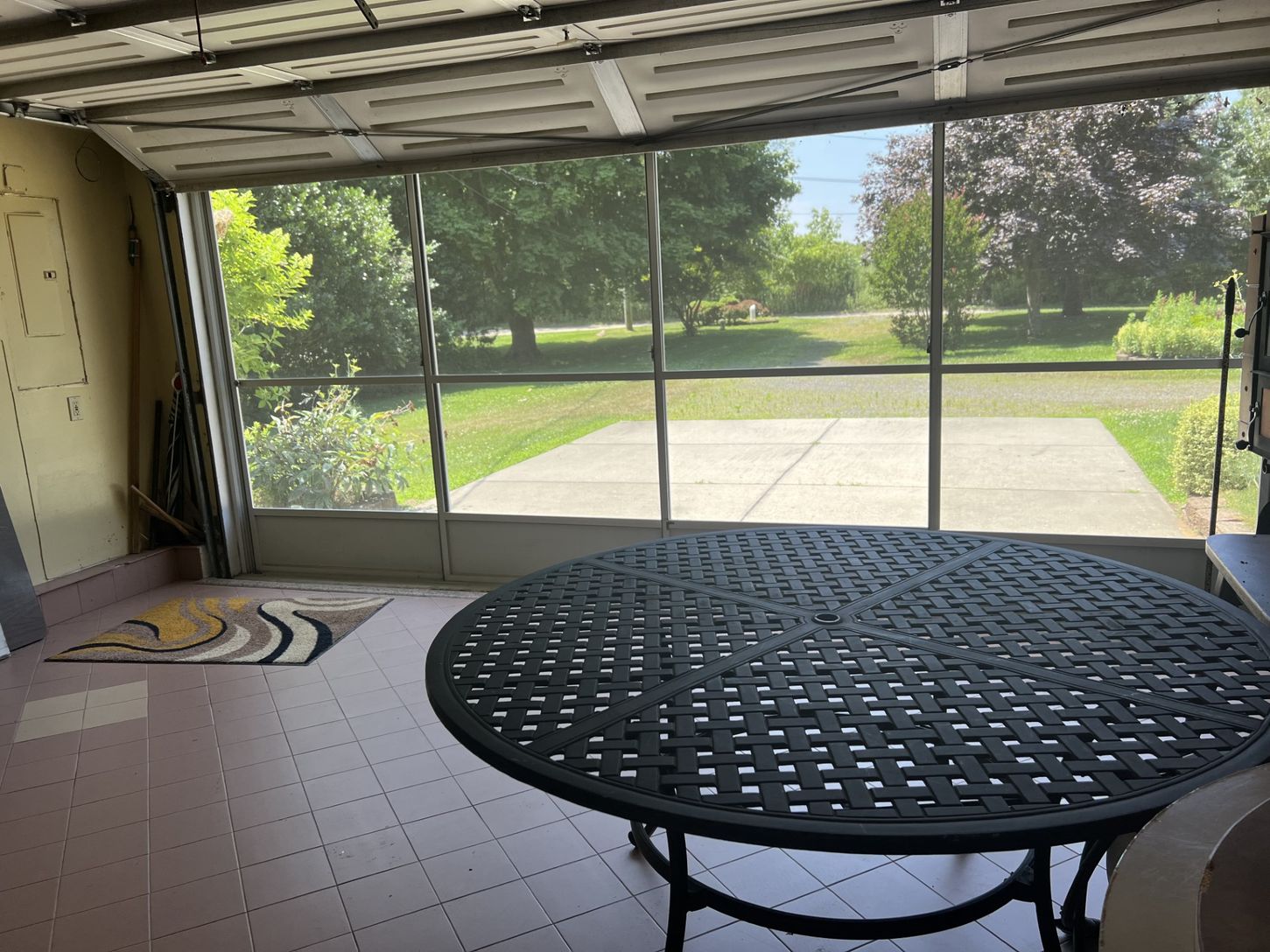 Garage overhead screen door that converts the space into a cool, casual hangout area for added enjoy