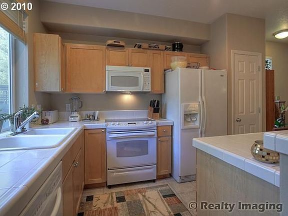 Bright Kitchen with island.Window overlooking private yard