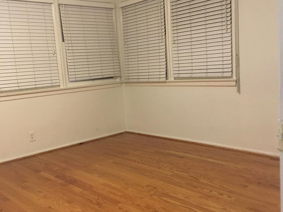 Bedroom with Roll Down Shutters. Shutters are on outside of the windows controlled by the wand on the right side of window.