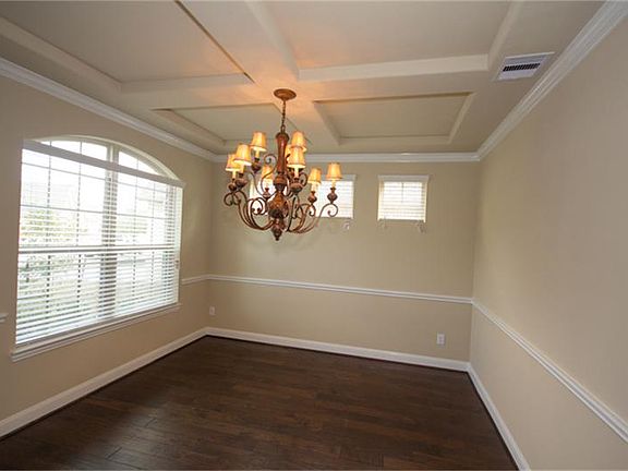 Elegant Formal Dining Rm features Upgraded Lighting, Accented Windows & beautiful Ceiling Detail! Gorgeous 5" Hickory Hardwood Plank Flooring throughout the Formal Dining, Entry, Family & Study!