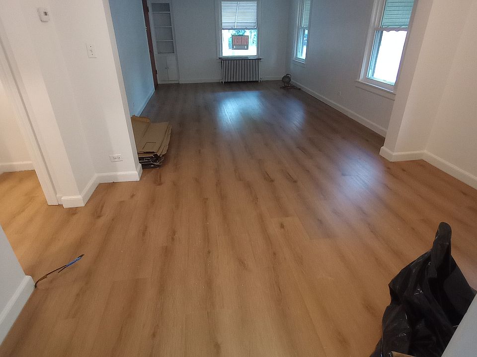 Dining room (9'x12') and living room (18'x12'). Showcasing newly installed floors (floors are also being installed in bedrooms)