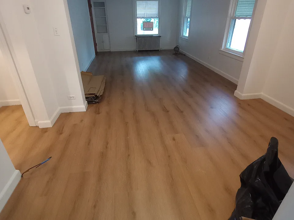 Dining room (9'x12') and living room (18'x12'). Showcasing newly installed floors (floors are also being installed in bedrooms)