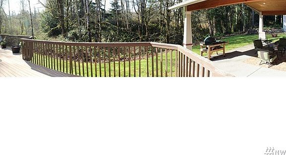 View from deck overlooking back property and covered patio area.