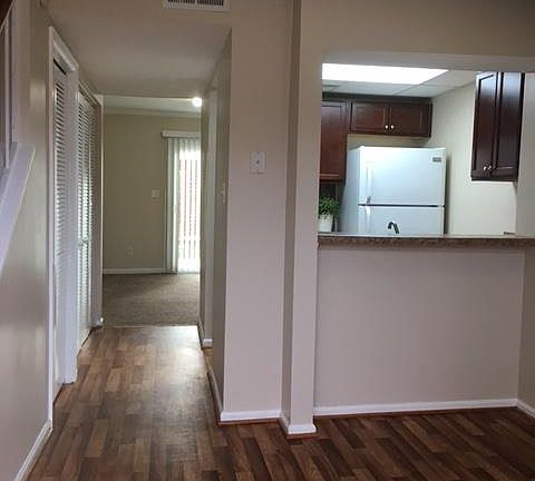 Stepping inside front door and looking through to den and back patio.