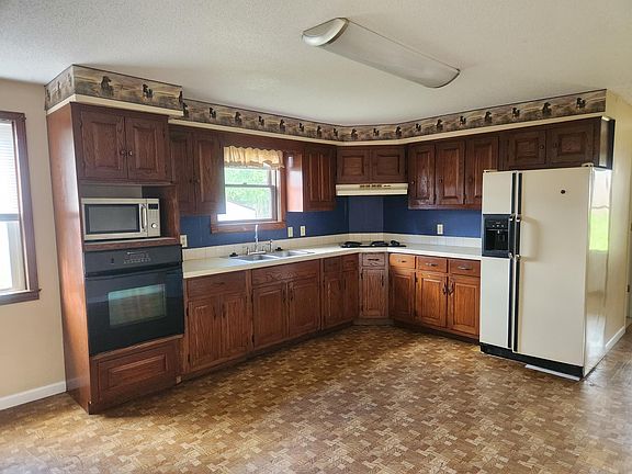 Plenty of room for your large kitchen table. Wood custom made cabinets.