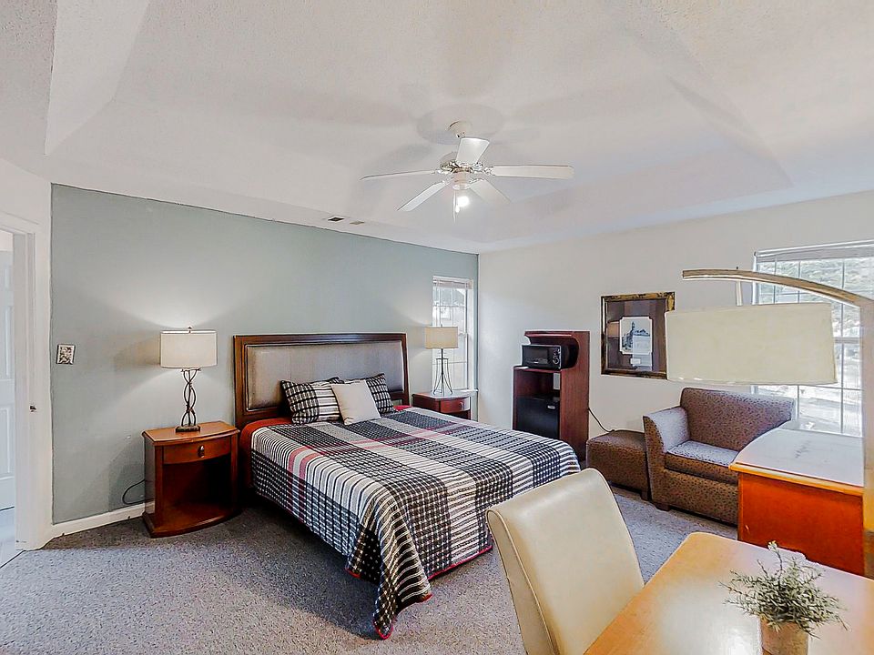 Large Master Bedroom with En-Suite bathroom with a tub. It has its own microwave and fridge along with two closets walk in