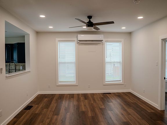 Large, open room. Perfect for a living room or dining room. Includes: mini split heat pump head, ceiling fan, dimmable lighting