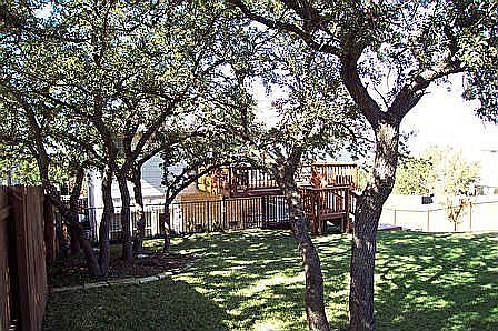 Back yard with view of deck off Master suite. NEW PICS OF FRONT COMING !!!